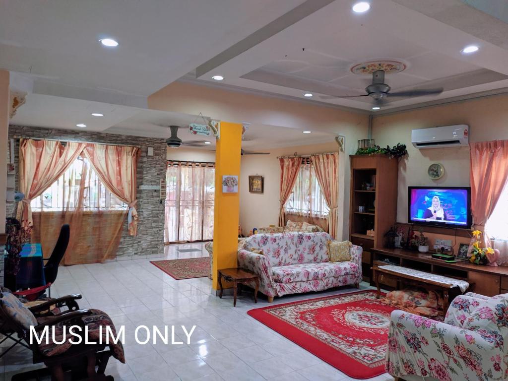 马六甲马六甲玛马西亚度假屋的带沙发和电视的客厅