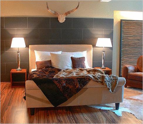 雷根斯堡元素酒店的一间卧室配有一张带两盏灯和两把椅子的床。