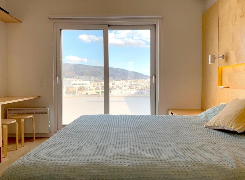 雅典Kolonaki Terrace的一间卧室设有一张床和一个大窗户