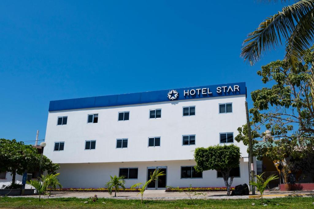 曼萨尼约恒星酒店的白色的建筑,上面有酒店标志