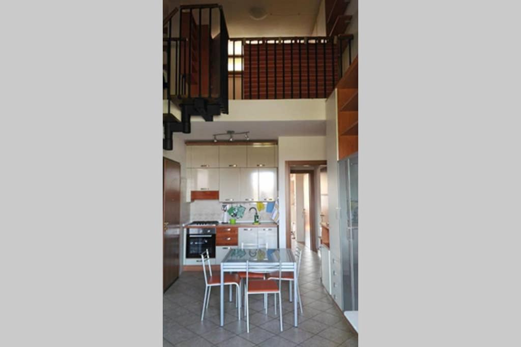 奥尔贝泰洛Appartamento sulla Laguna的厨房以及带桌椅的用餐室。