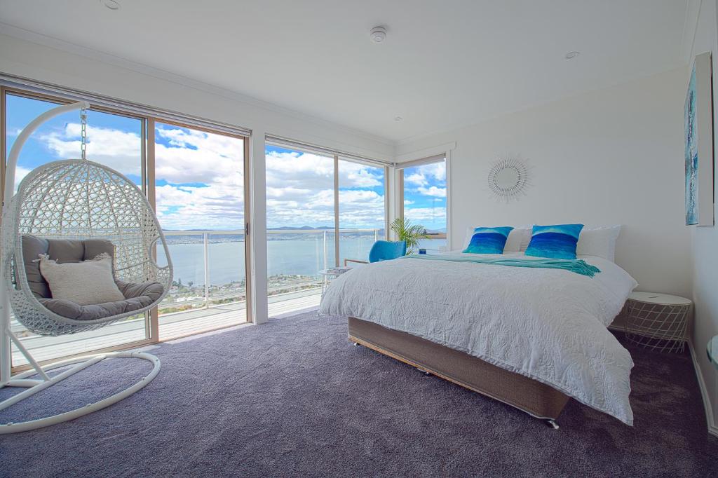 霍巴特Nature & Relax House, Panoramic sea view, Free parking 37的卧室设有秋千床和大窗户。