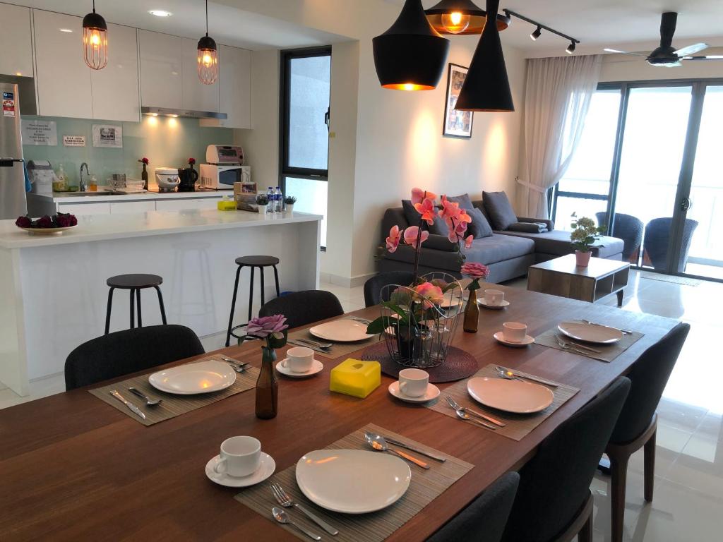 努沙再也Teega Residence @ Cosy Seafront Living的餐桌,上面有盘子和餐具