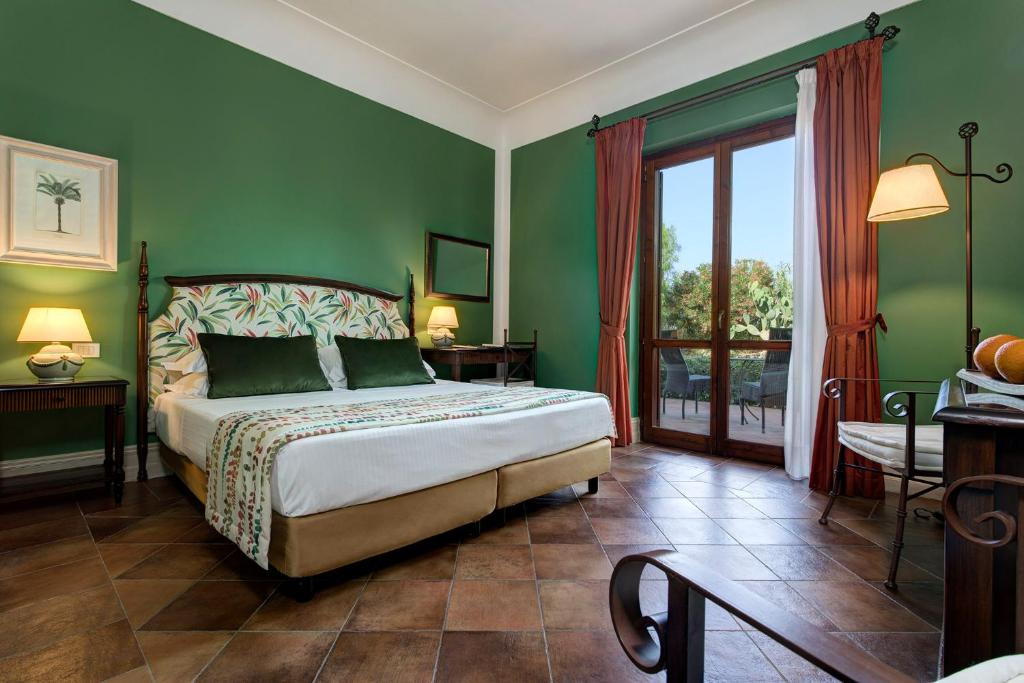 Hotel Baglio Oneto dei Principi di San Lorenzo - Luxury Wine Resort客房内的一张或多张床位