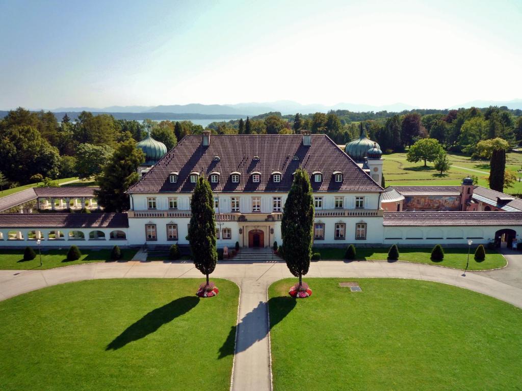 贝尔恩里德Schloss Höhenried的前面树木繁茂的大房子的空中景色