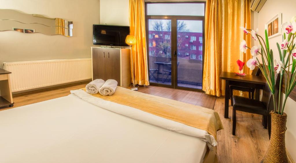 布加勒斯特EOS酒店的酒店客房,配有带毛巾的床