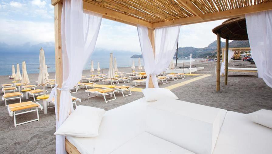 勒托阳尼席雷西雅酒店的海滩上的卧室配有白色的床和椅子