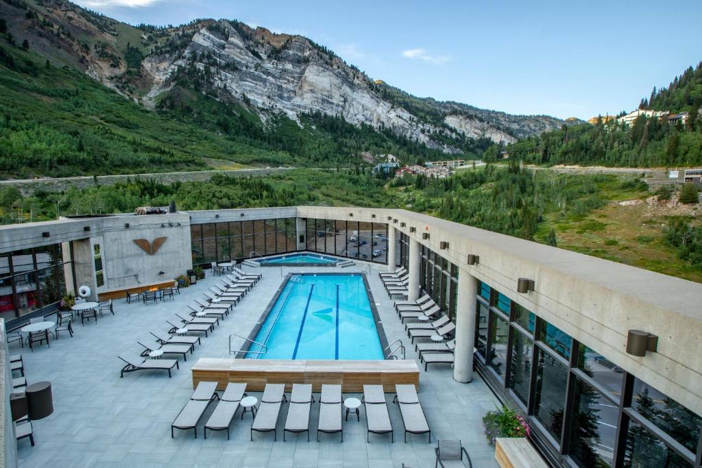 雪鸟洛奇克里夫旅馆&Spa酒店的一座带游泳池、椅子和山地的酒店