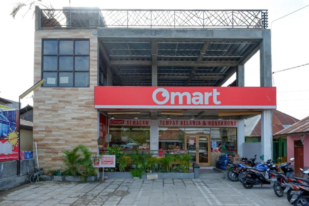 哥伦打洛省RedDoorz Syariah near Universitas Negeri Gorontalo 2的停在前面的摩托车智能商店
