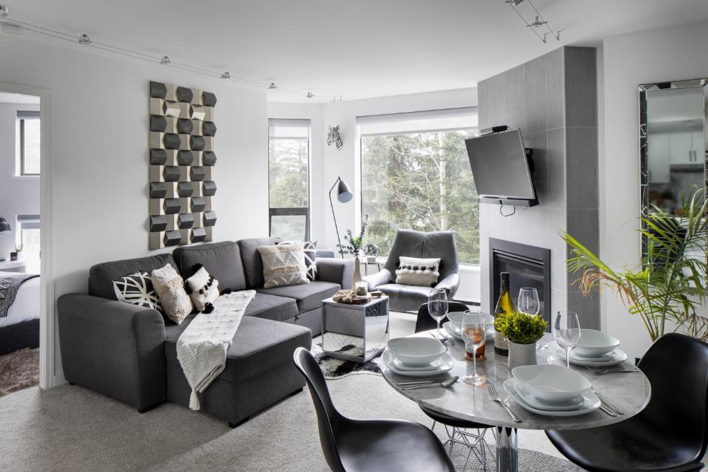惠斯勒The Modern Whistler Apartment - Ski-in ski-out的客厅配有沙发和桌椅