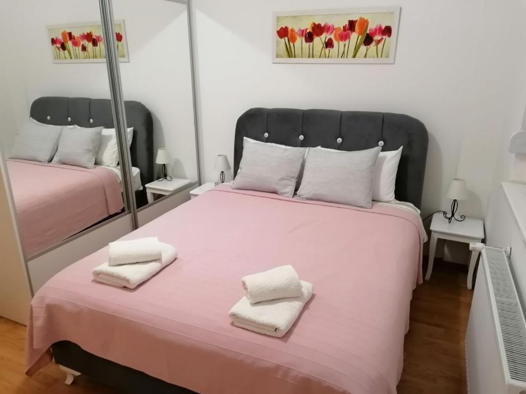 巴尼亚科维利亚查Apartment Kraljica的一间卧室配有一张大床和两条毛巾