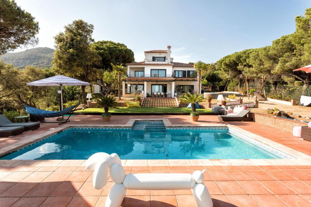 阿雷尼斯-德蒙特Villa Costa Barcelona的一座带游泳池和房子的别墅