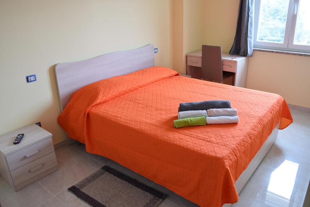 维博瓦伦蒂亚Stella d'Oro的一间卧室配有橙色床和2条毛巾