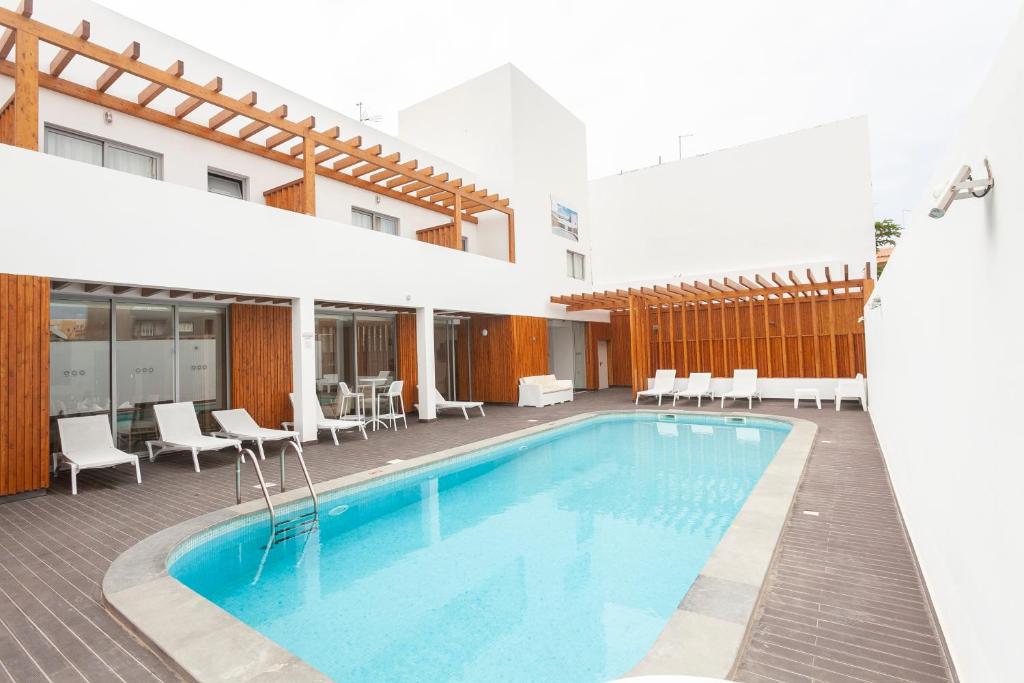 圣玛丽亚Hotel Da Luz的一座配有桌椅的酒店游泳池