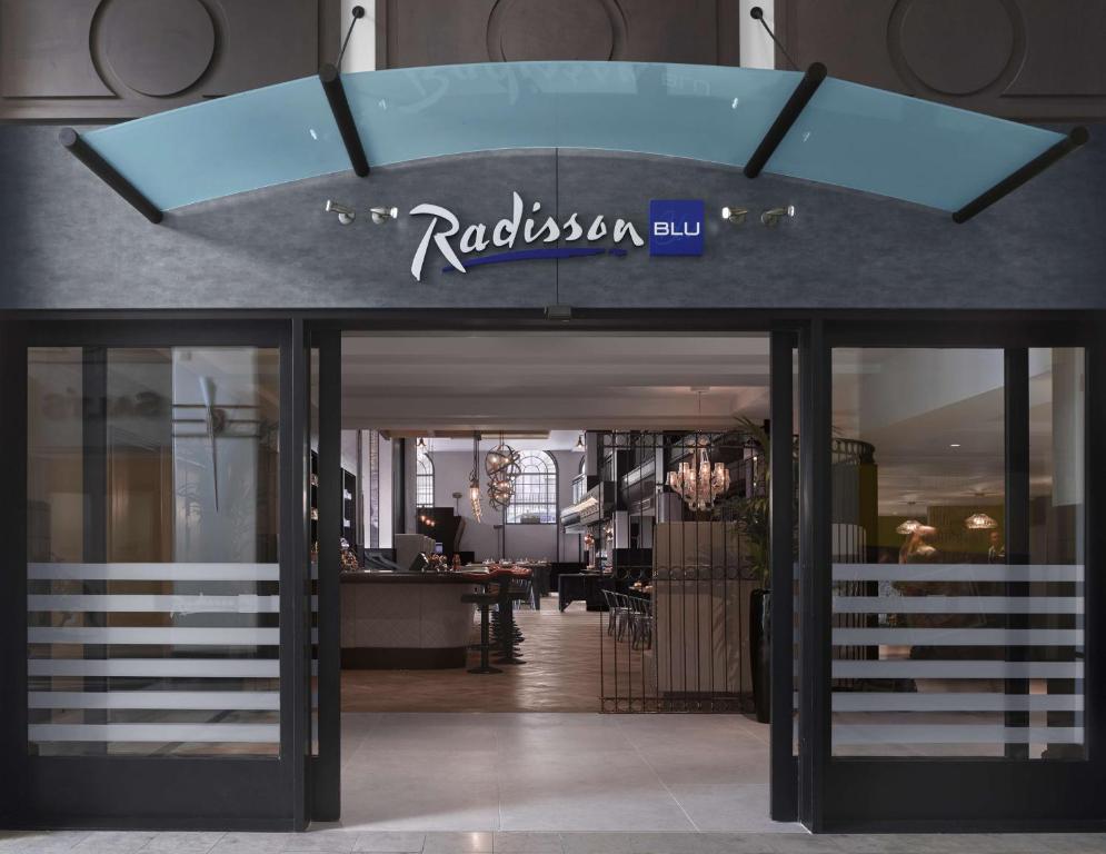 利兹Radisson Blu Hotel, Leeds City Centre的大楼前有标志的餐厅