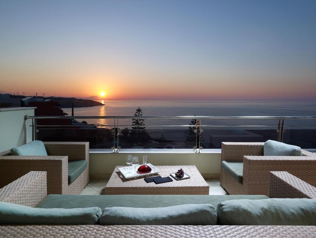 罗希姆诺马卡利斯套房酒店及Spa的日落时分享有海洋美景的阳台