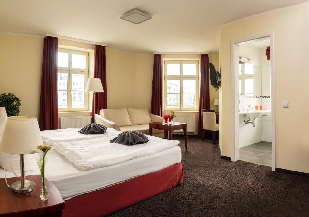 莱比锡施拉加特公寓酒店的酒店客房,配有床和沙发