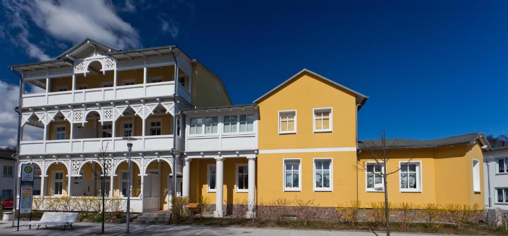 奥斯赛拜-塞林Haus Sonne的蓝色天空的黄色和白色建筑