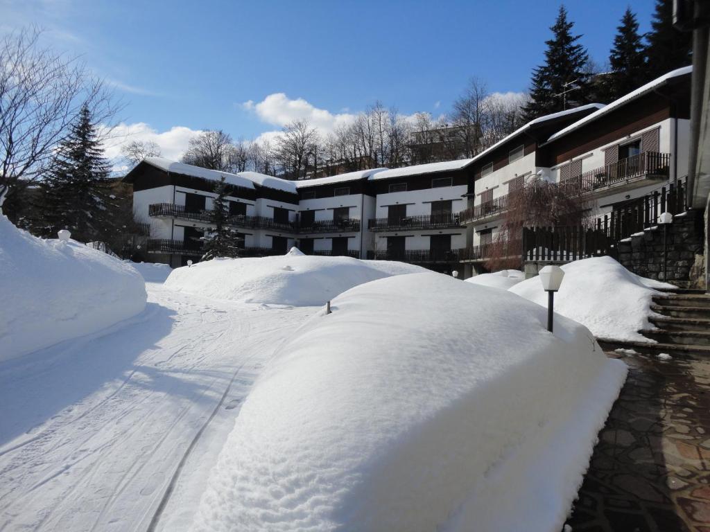 皮耶韦佩拉戈穆里纳西奥公寓式酒店的建筑物前的一堆积雪