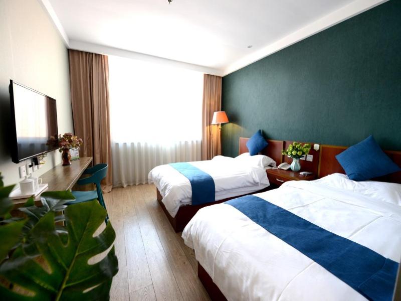 烟台贝壳烟台山公园酒店的酒店客房设有两张床和电视。