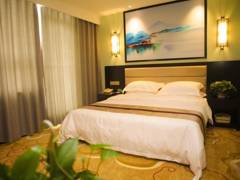 德州格林联盟德州宁津县正阳路德百广场酒店的一间位于酒店客房内的带大床的卧室