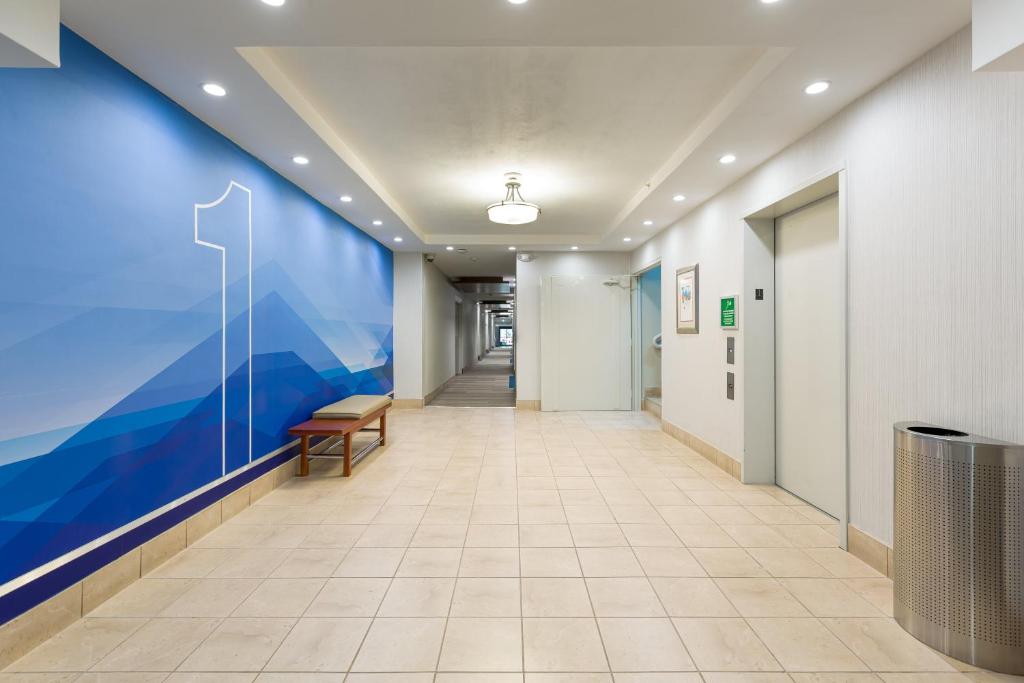 阿拉胡埃拉圣何塞机场智选假日酒店的医院里一条有蓝色墙的走廊