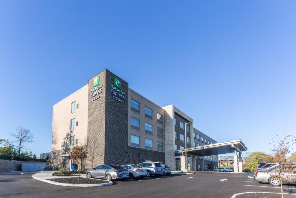 弗洛伦斯Holiday Inn Express & Suites - Florence - Cincinnati Airport, an IHG Hotel的停车场内有车辆的建筑物