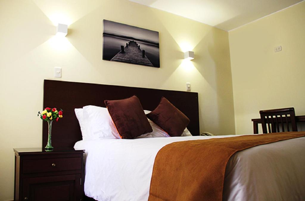 利马Hotel Ferrua的一间卧室配有带白色床单和枕头的床。