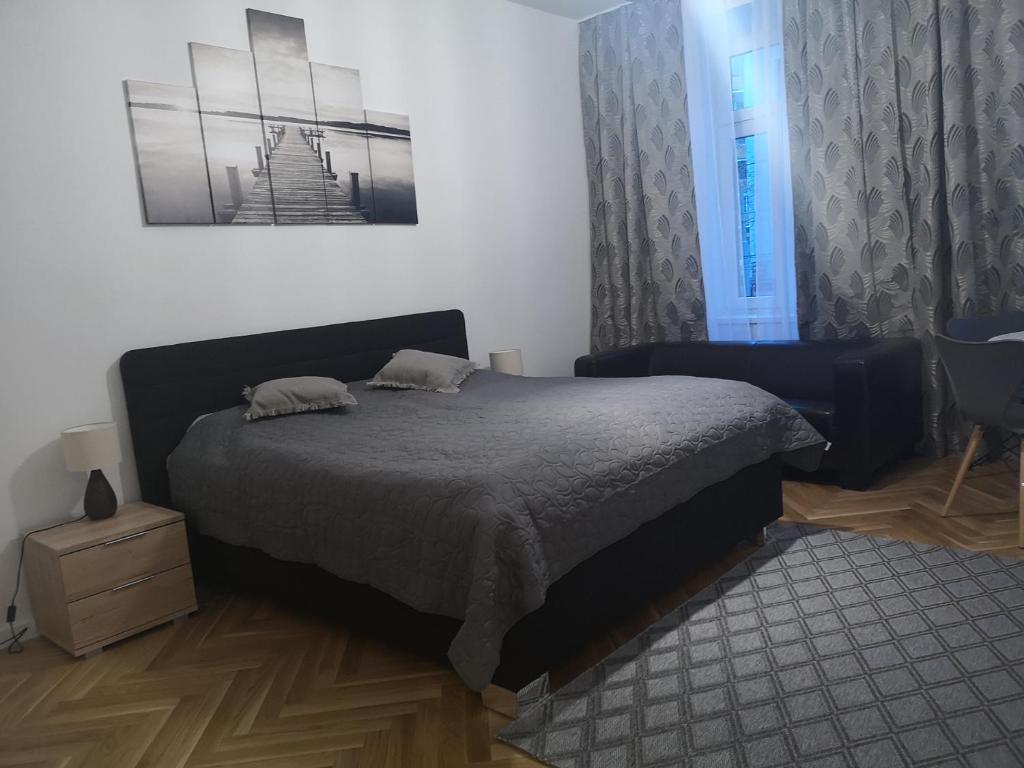 维也纳Angelika Apartments的卧室配有床、椅子和窗户。
