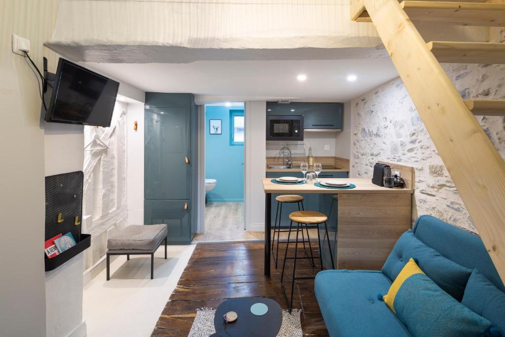 雷恩Ty Color's的一间带蓝色沙发的客厅和一间厨房