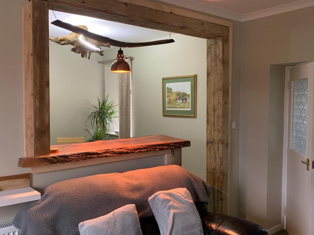 阿伯劳尔The Cottage Aberlour的一间卧室配有一张带镜子和天花板的床