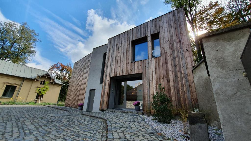 马达伯乐斯拉夫Exclusive penzion Viva Residence的一座带石头车道的木外墙房子