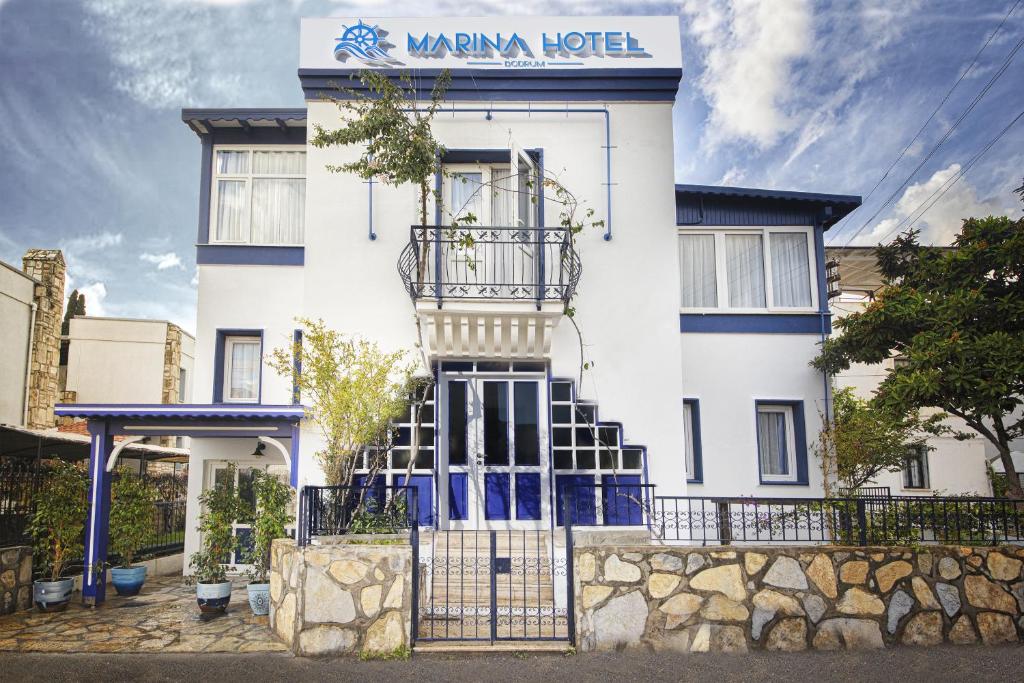 博德鲁姆Marina Hotel Bodrum的白色的建筑,上面有标志