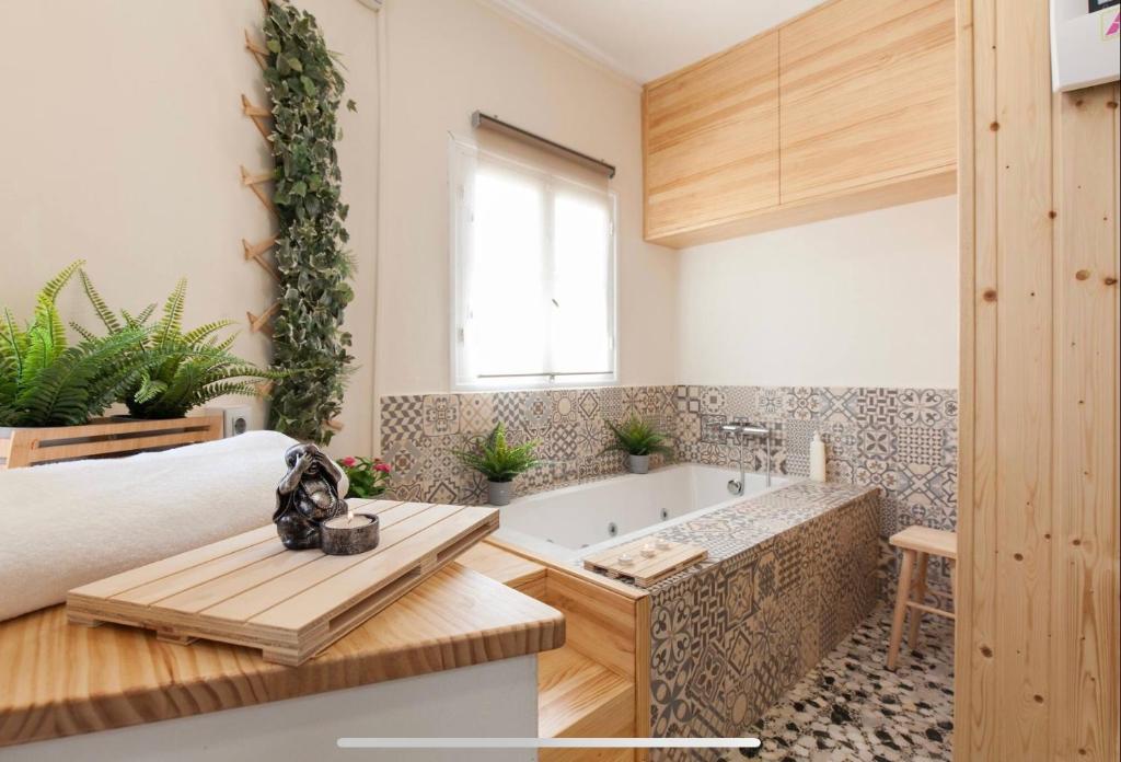 阿尔么丽亚Boutike Wellness Centro Almería的带浴缸和桌子的客房