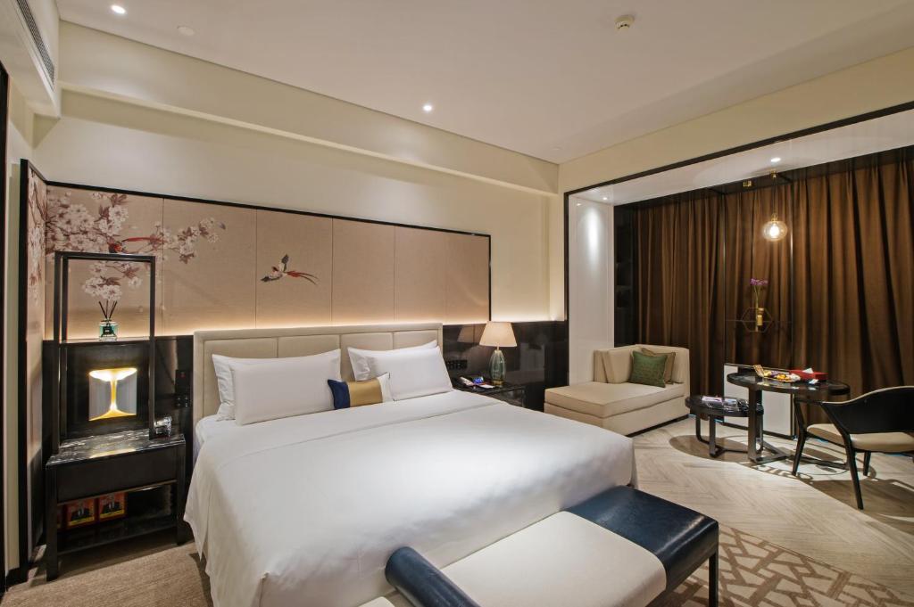 成都润邦国际酒店的卧室配有一张白色大床和一张书桌