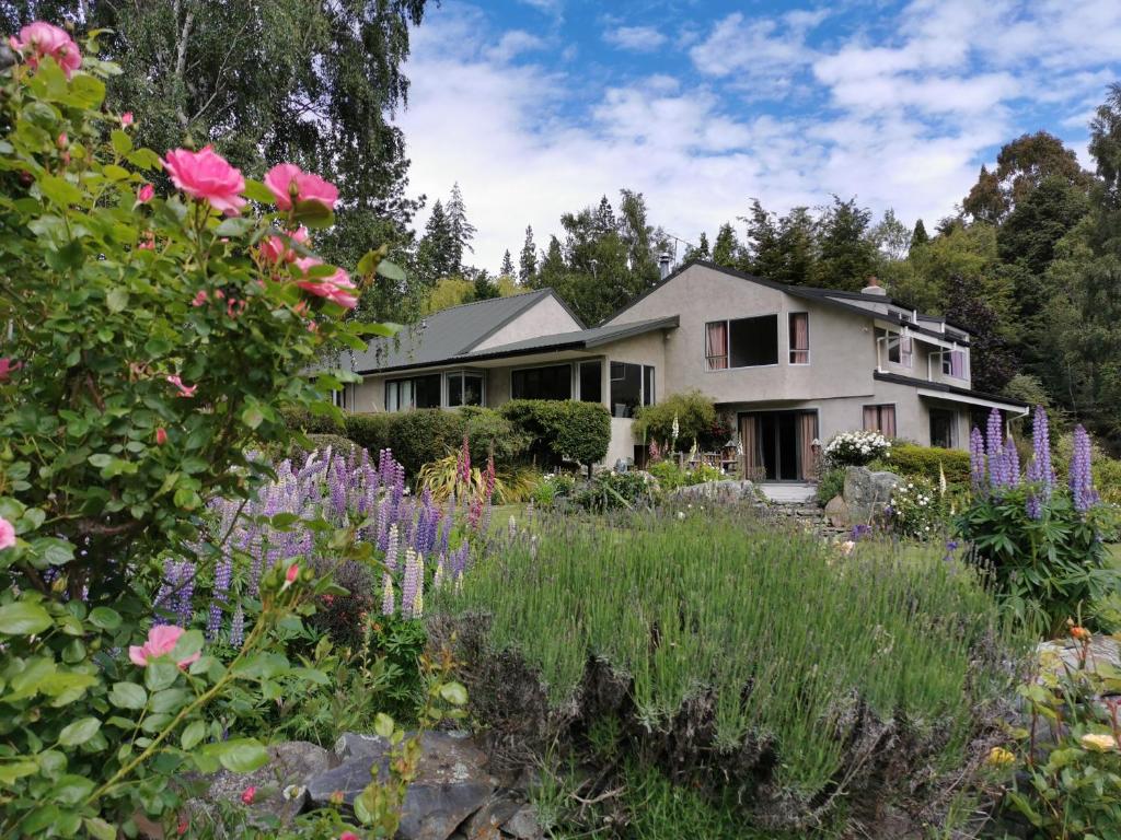 特卡波湖Star Dream Manor的一座房子,前面有一个种着鲜花的花园