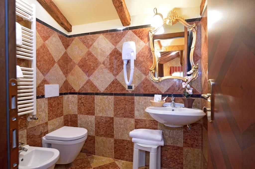 威尼斯安缇卡帕纳达酒店的一间带水槽、卫生间和镜子的浴室