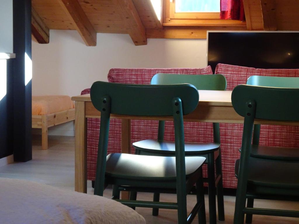 阿尔代兹B&B Chasa Arfusch的配有椅子、桌子和床的房间