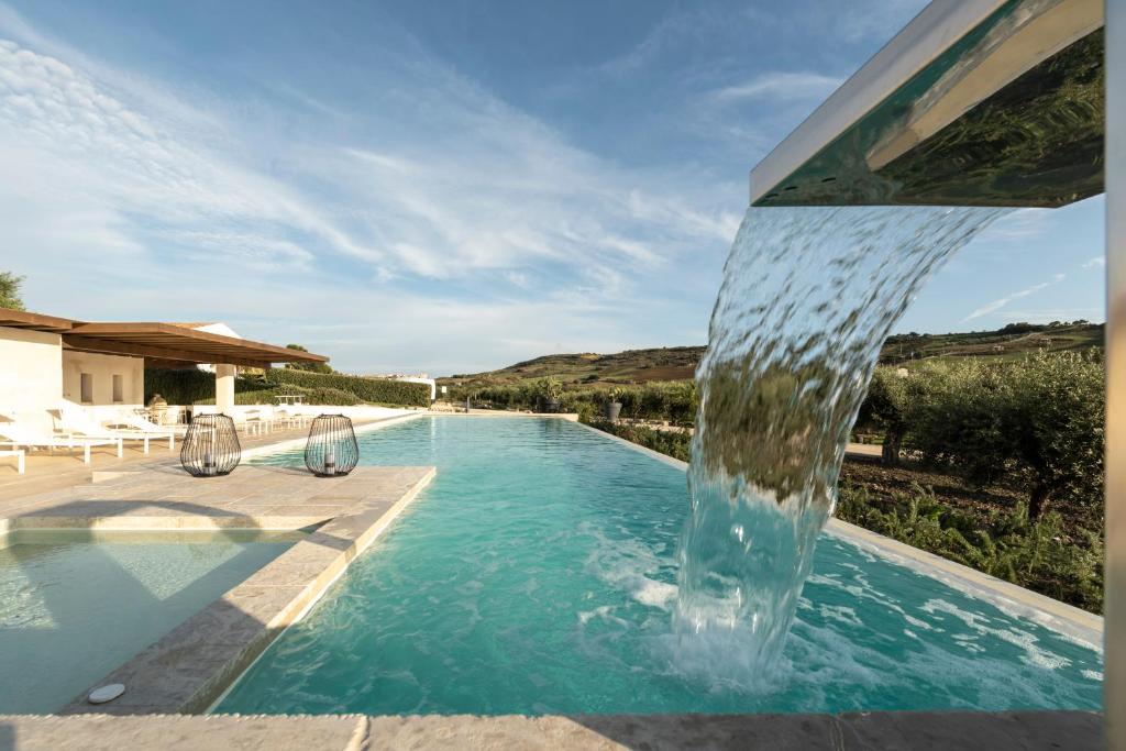 雷阿尔蒙特Borgo Giallonardo Wine Relais的一个带喷泉的游泳池