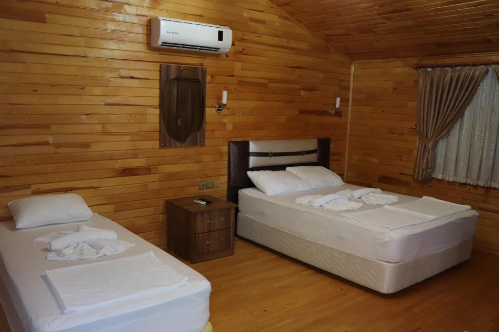 契拉勒普拉节酒店的木墙客房的两张床