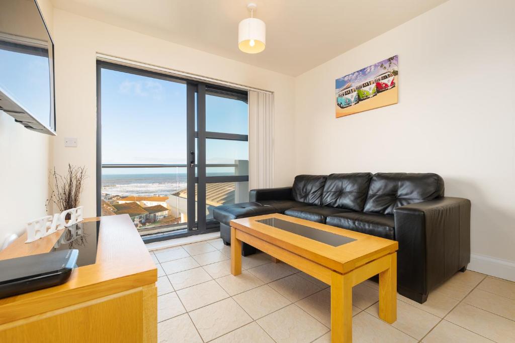 韦斯特沃德霍West Beach - Holiday Apartments的客厅配有真皮沙发和桌子