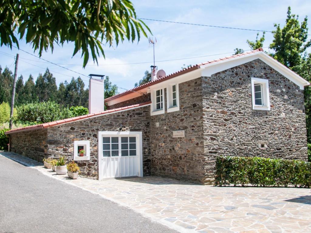 蓬特德乌梅Holiday Home El Olivo by Interhome的一座石头房子,设有白色车库