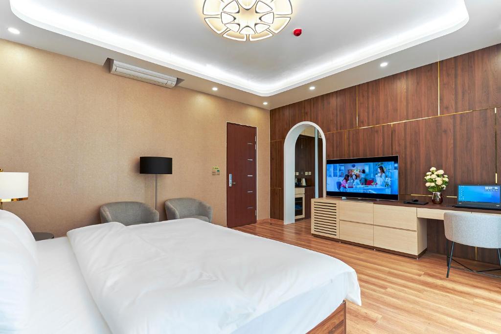 下龙湾BBQ Hostel Ha Long 2的一间卧室配有一张床和一台平面电视