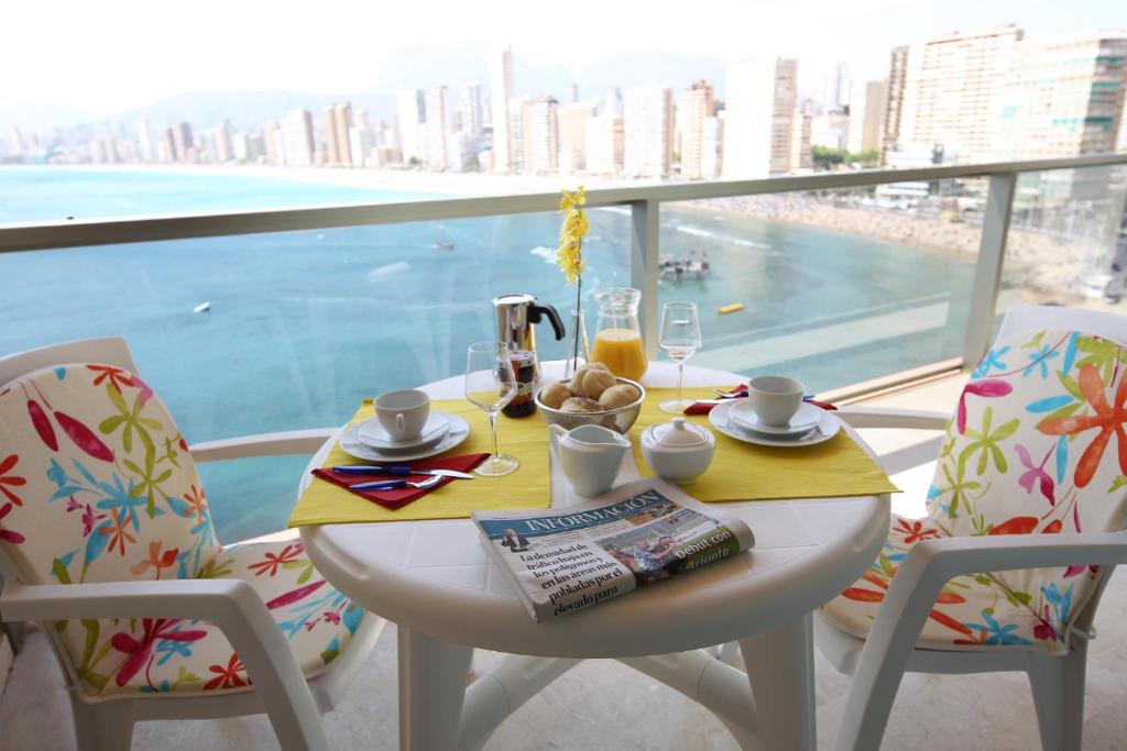 贝尼多姆丽都公寓酒店的美景阳台的餐桌和早餐