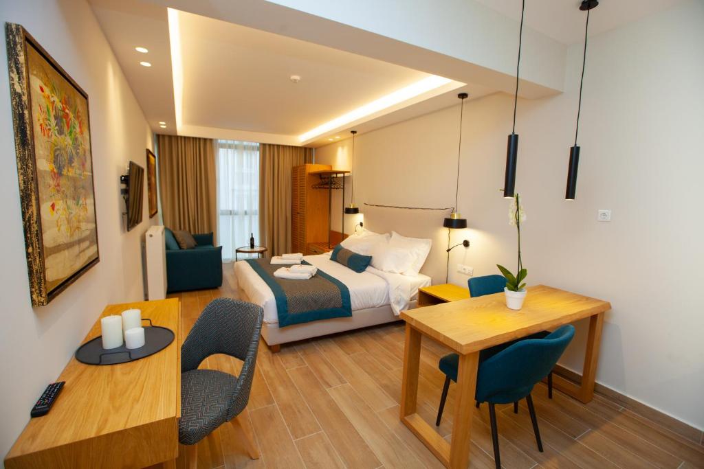 塞萨洛尼基No21 Luxury Suites的酒店客房带一张床、一张桌子和椅子