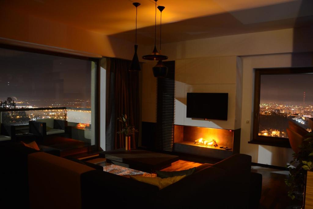 布拉索夫Juniper Apartment的一间带壁炉的客厅,享有城市美景