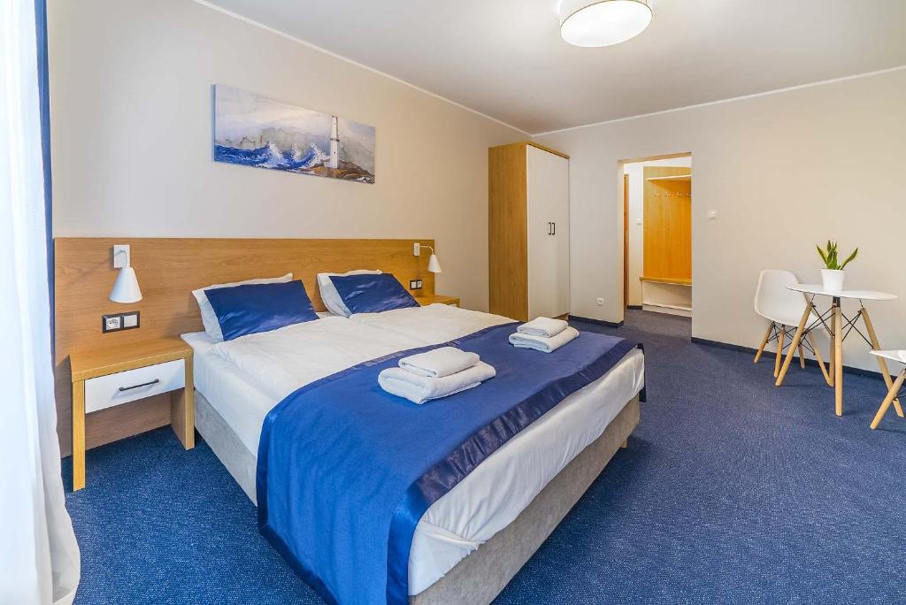 弗瓦迪斯瓦沃沃Navii的酒店客房,配有一张带蓝色床单的大床