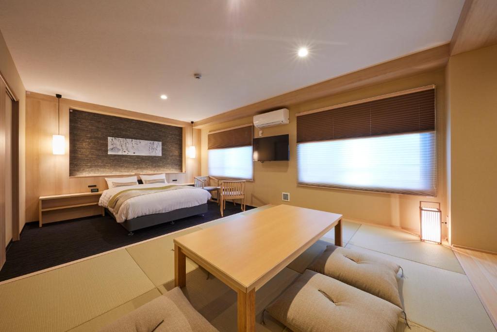 京都Rinn Shirakawa South的酒店客房配有一张床铺和一张桌子。
