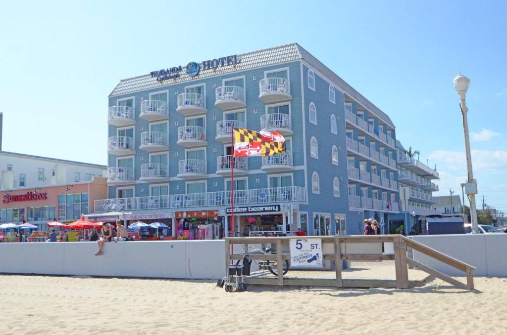 大洋城滩涂加勒比海滩涂浮桥套房酒店的沙滩上一座蓝色的大建筑