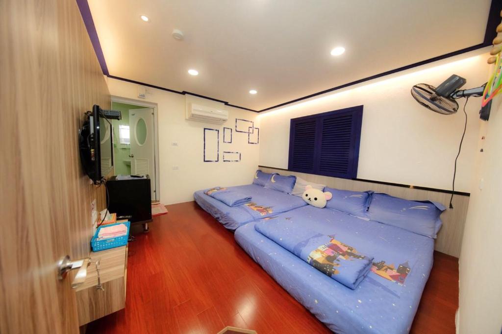 小琉球岛小琉球琉恋民宿的一间卧室配有蓝色大床和蓝色枕头